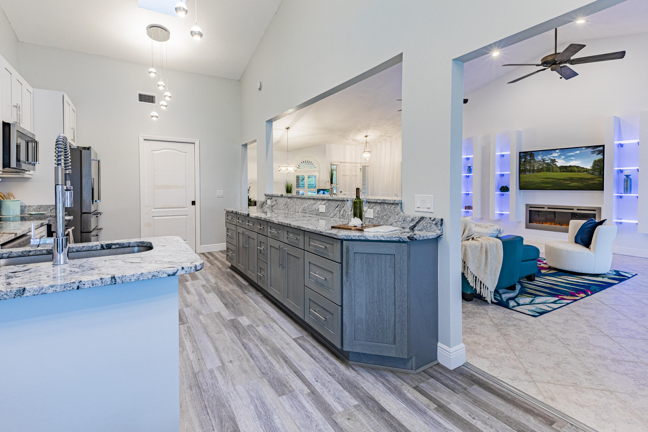 569 Dawson Drive Melbourne, FL 32940 - Photo 14 of 38 a living room with granite countertop furniture a flat screen tv and kitchen view