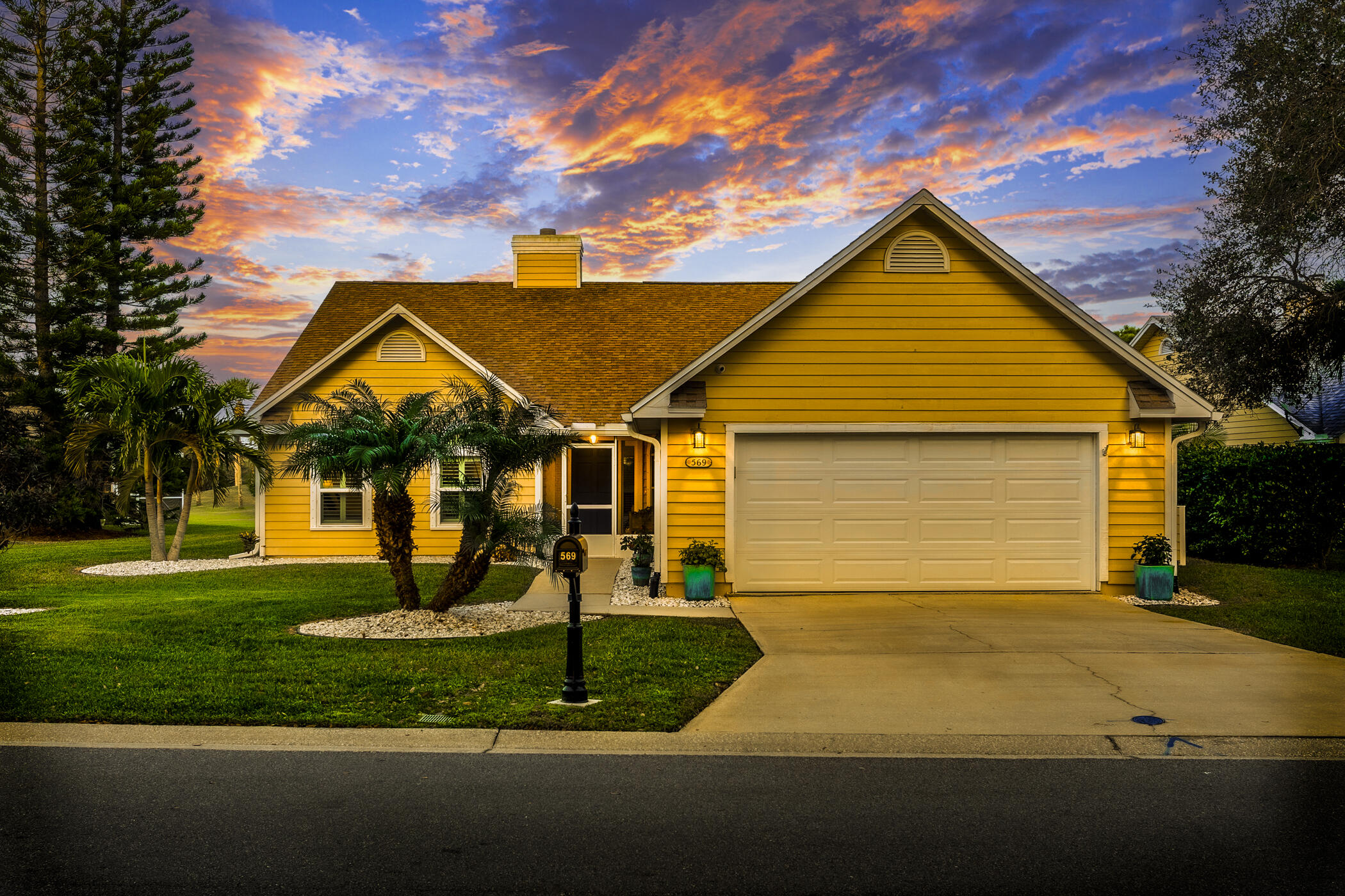 569 Dawson Drive Melbourne, FL 32940 - Photo 2 of 38 a front view of a house with a yard and garage