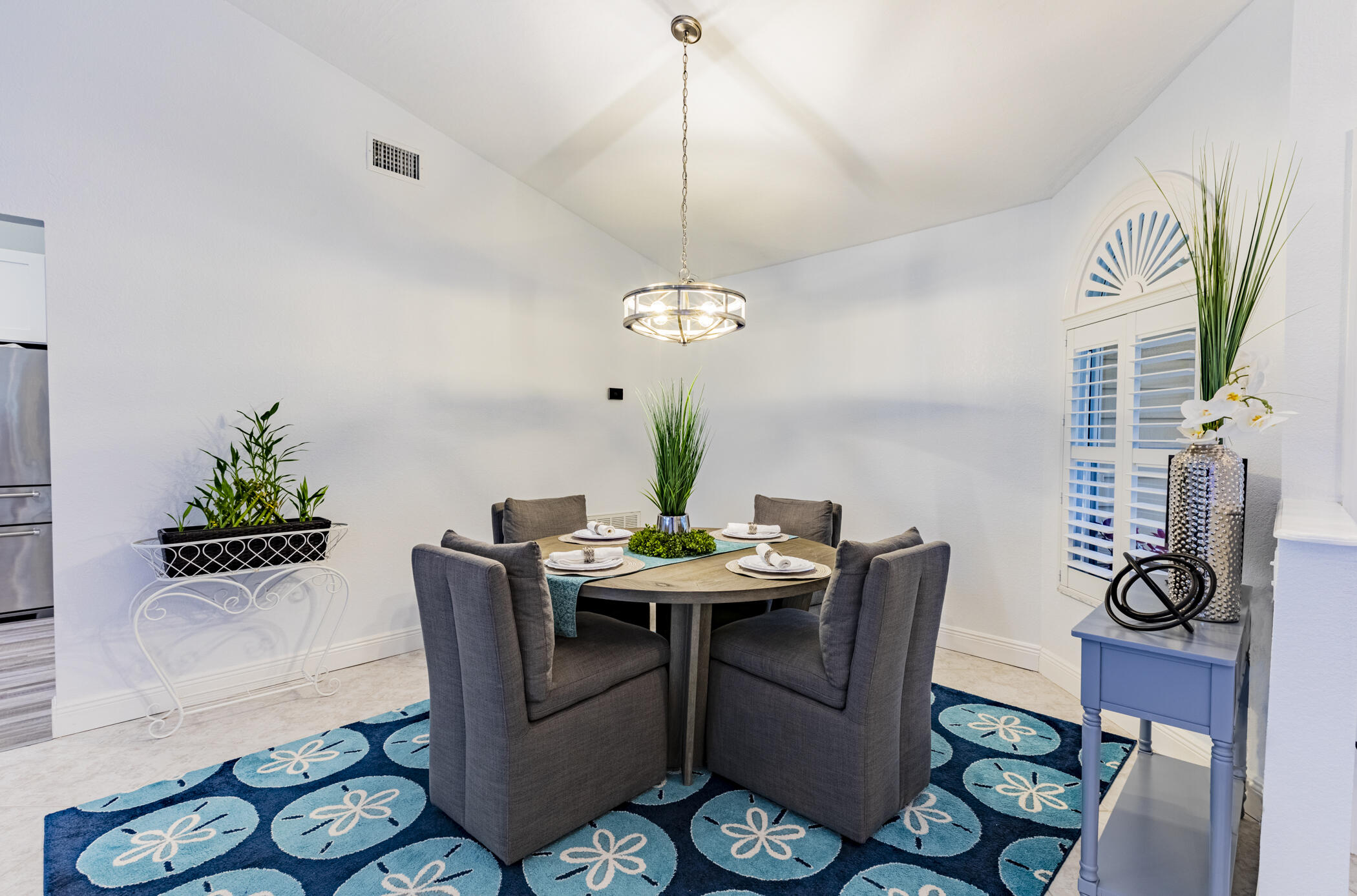 569 Dawson Drive Melbourne, FL 32940 - Photo 21 of 38 a dining room with furniture potted plants and wooden floor