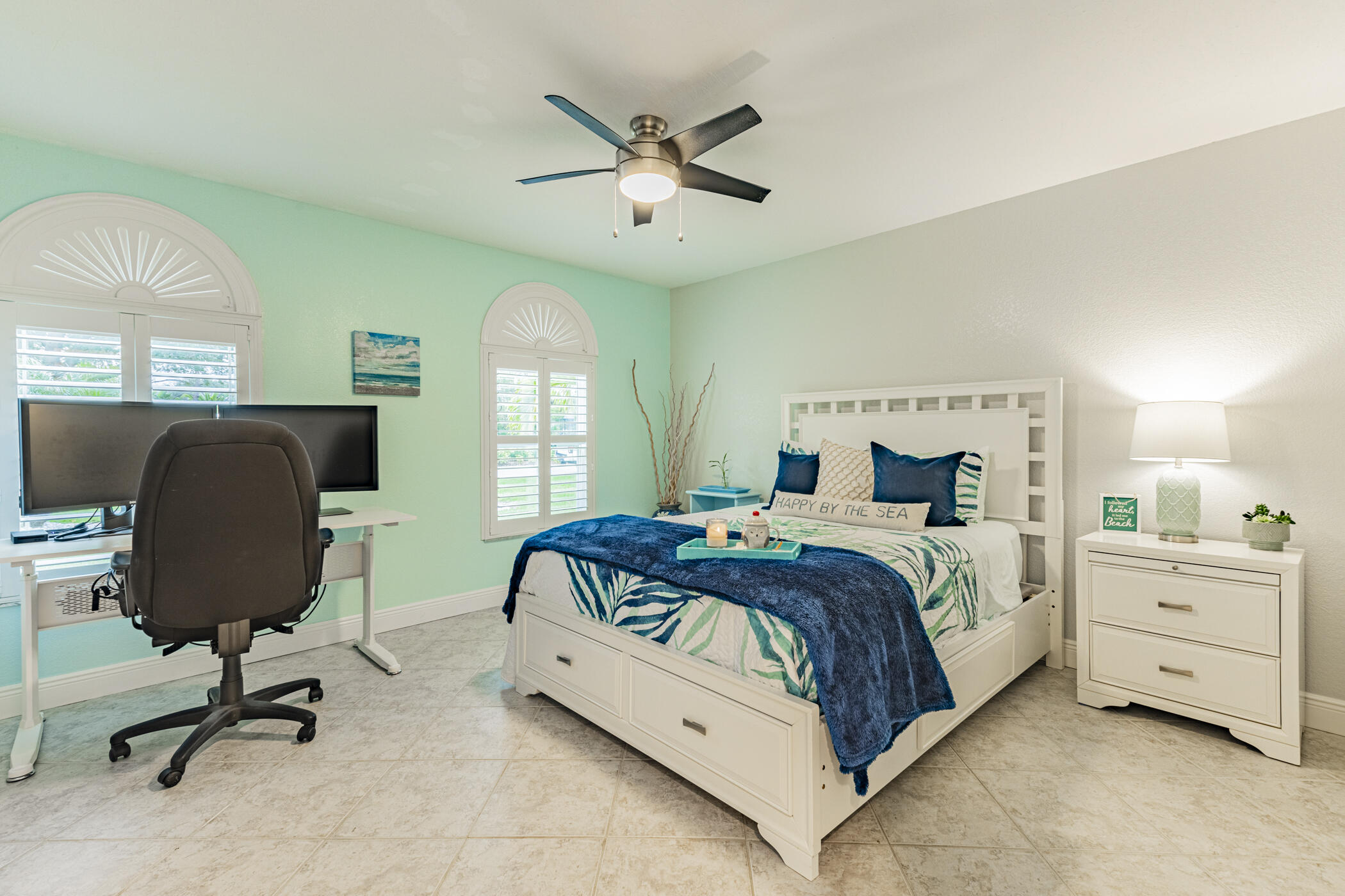 569 Dawson Drive Melbourne, FL 32940 - Photo 27 of 38 a bedroom with a large bed and a chandelier