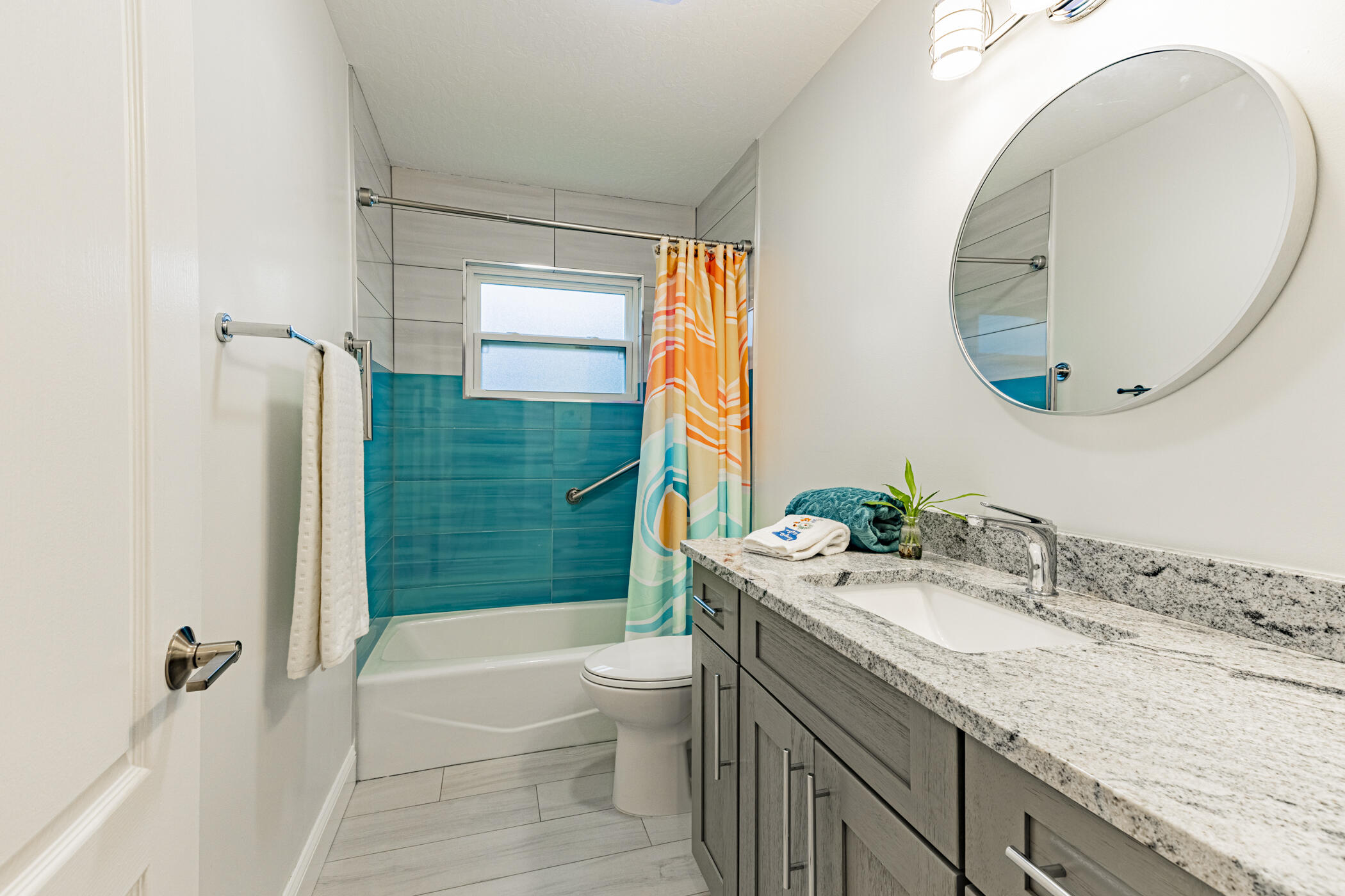 569 Dawson Drive Melbourne, FL 32940 - Photo 29 of 38 a bathroom with a granite countertop sink a toilet and shower