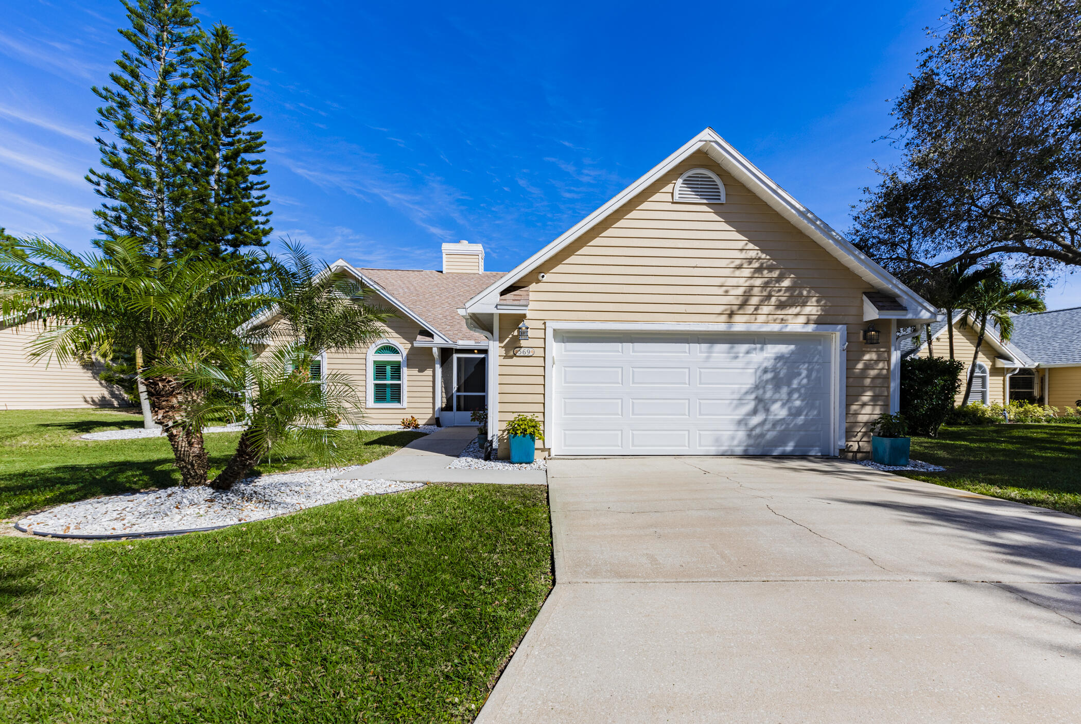 569 Dawson Drive Melbourne, FL 32940 - Photo 3 of 38 a front view of a house with a yard and garage