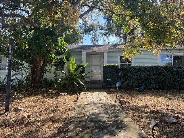 a view of a house with a yard and tree s