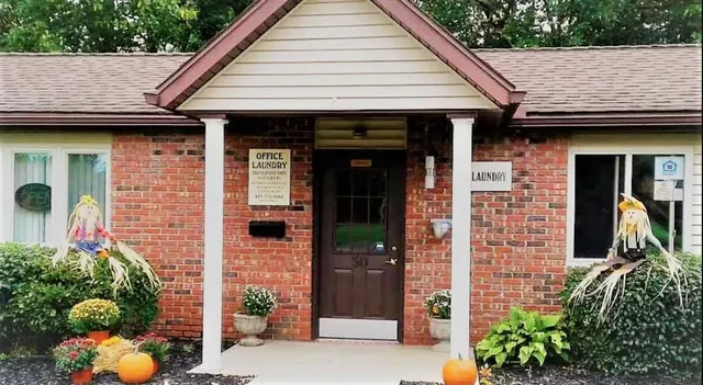 a view of a brick house with potted plants