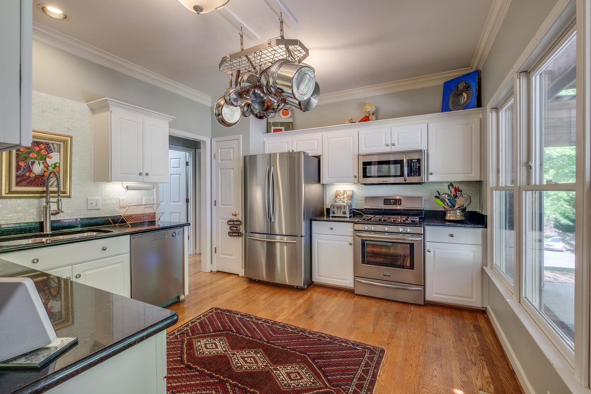 8224 Spring Ridge Drive Nashville, TN 37221 - Photo 8 of 25 tile backsplash, stainless appliances, hardwood floors, gas stove are the highlights in the kitchen.