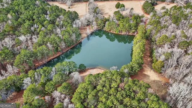 an aerial view of a house with a yard and lake view