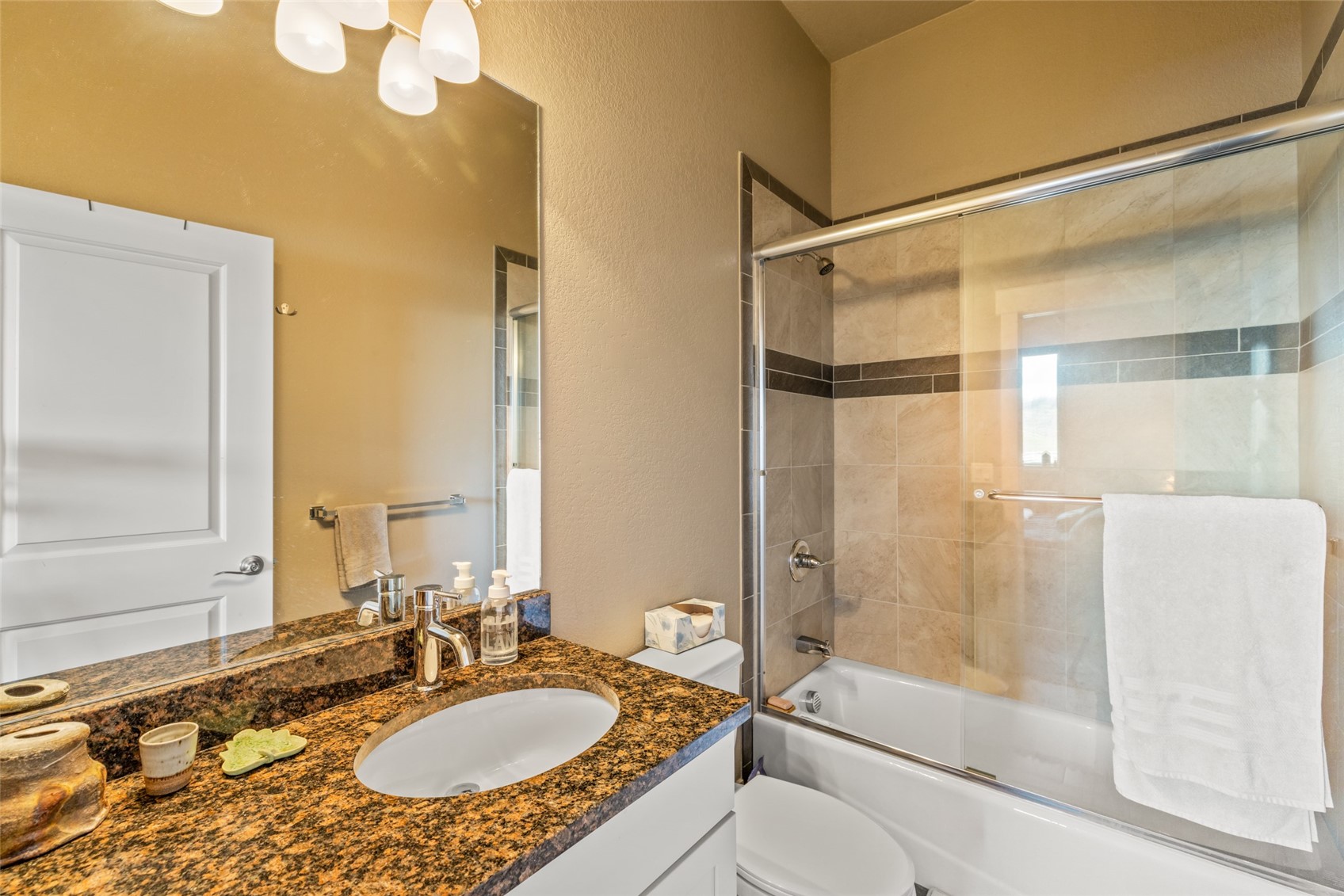 1680 Copper Ridge Drive, Unit 101 Steamboat Springs, CO 80487 - Photo 16 of 21 a bathroom with a granite countertop sink mirror bathtub and shower
