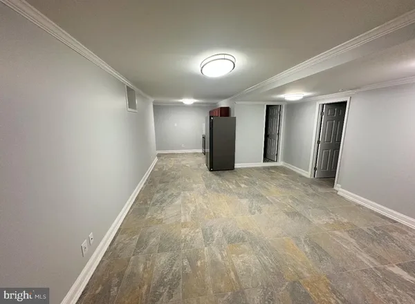 an empty room with closet and wooden floor