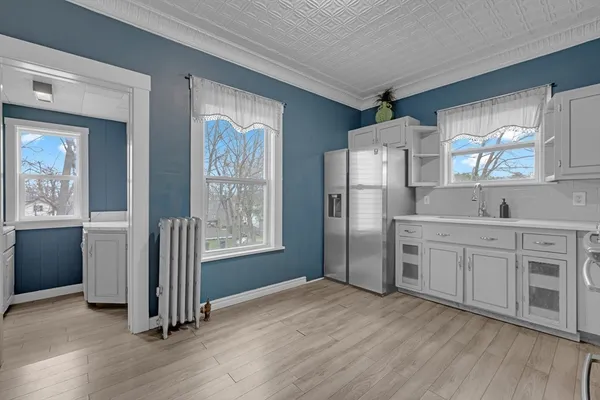 a kitchen with stainless steel appliances a refrigerator sink and cabinets