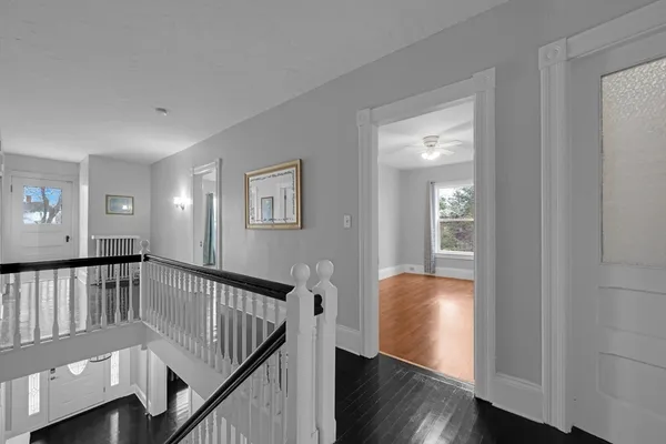 a view of entryway with wooden floor and stairs