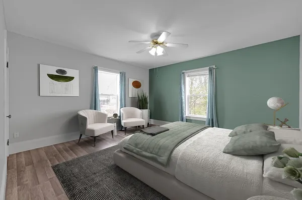 a bedroom with a bed couch and window