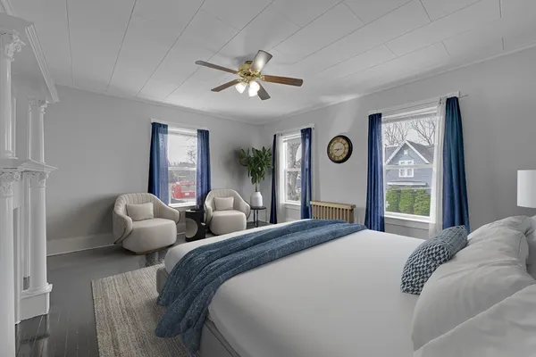 a bedroom with a bed and a chandelier