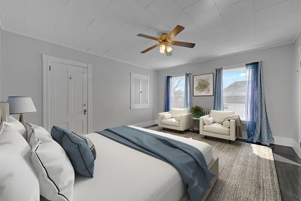 a bedroom with a bed couch and window