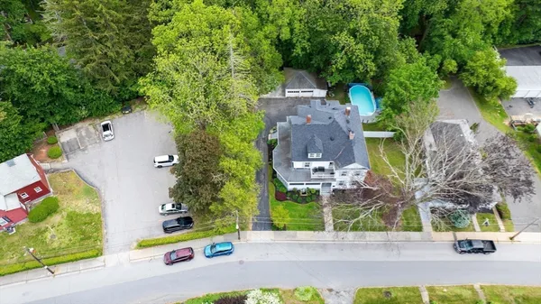 an aerial view of a house with a yard and garden