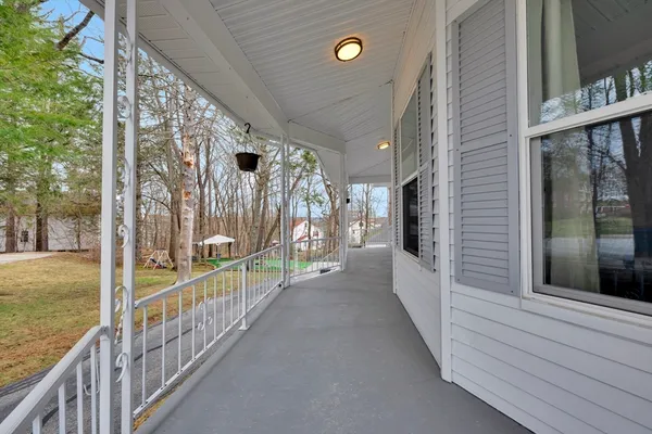 a view of a porch with wooden floor and fence