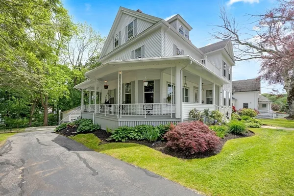 a front view of a house with a garden and plants