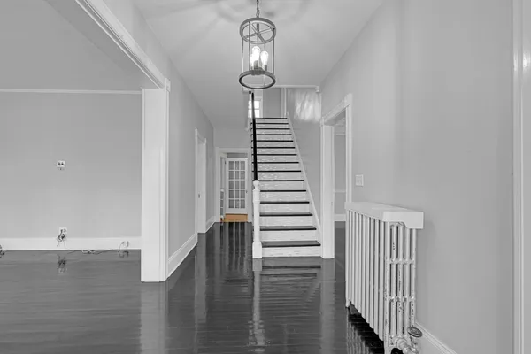 a view of entryway and hall with wooden floor