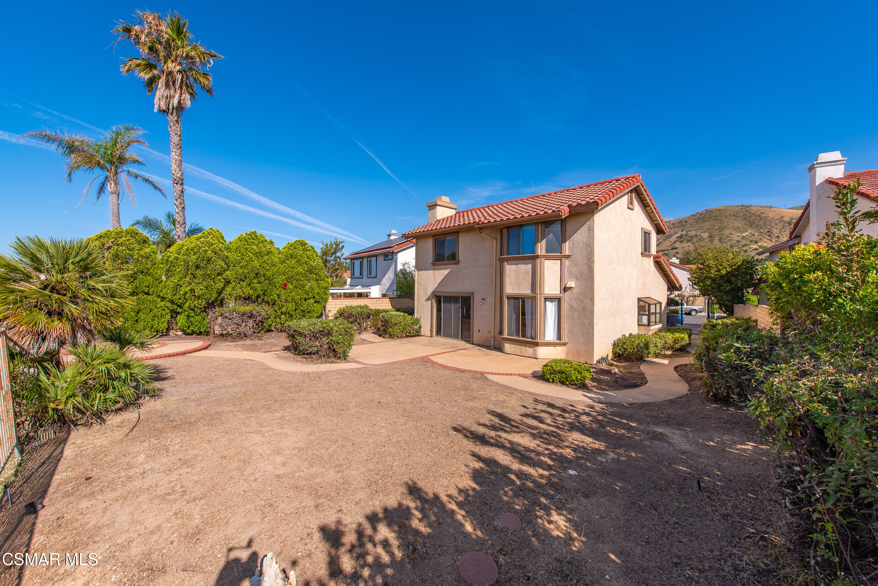 12036 Shadow Ridge Way Porter Ranch, CA 91326 - Photo 11 of 35 a front view of a house with a yard and a garage