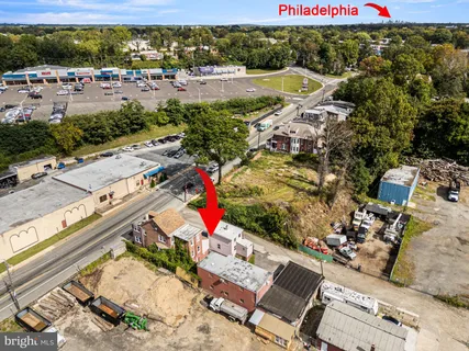an aerial view of residential houses with outdoor space and trees