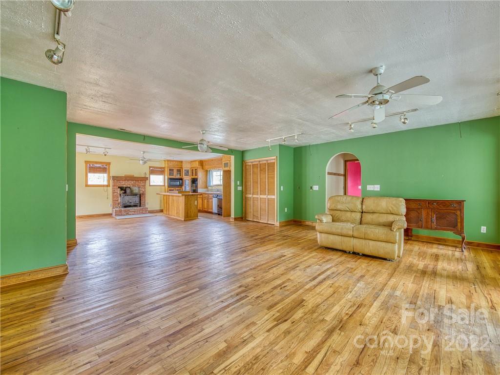 217 Durham Road Clyde, NC 28721 - Photo 11 of 24 a living room with furniture and a wooden floor