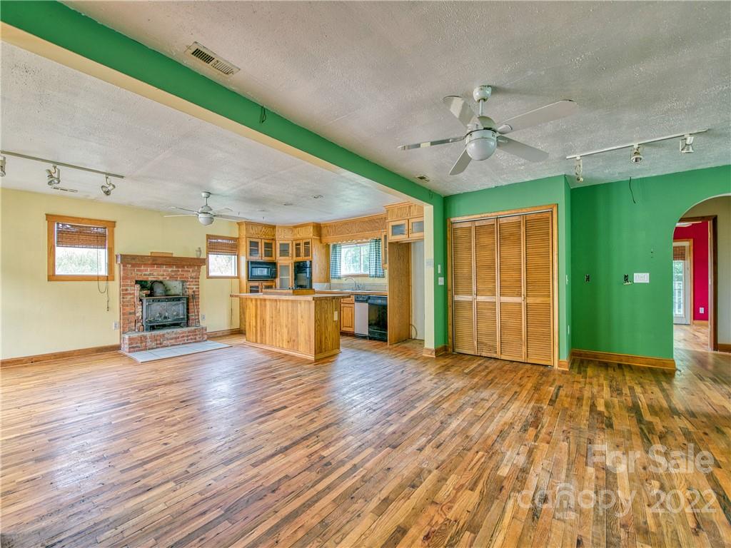217 Durham Road Clyde, NC 28721 - Photo 12 of 24 a view of an empty room with window and wooden floor