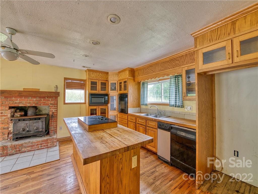 217 Durham Road Clyde, NC 28721 - Photo 15 of 24 a kitchen with stainless steel appliances granite countertop a stove and a refrigerator