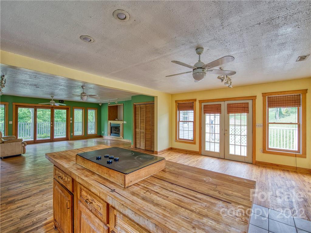 217 Durham Road Clyde, NC 28721 - Photo 16 of 24 a living room with kitchen island granite countertop furniture and a large window