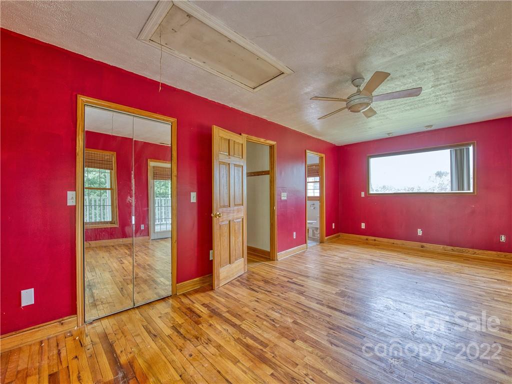 217 Durham Road Clyde, NC 28721 - Photo 22 of 24 a view of empty room with wooden floor and fan