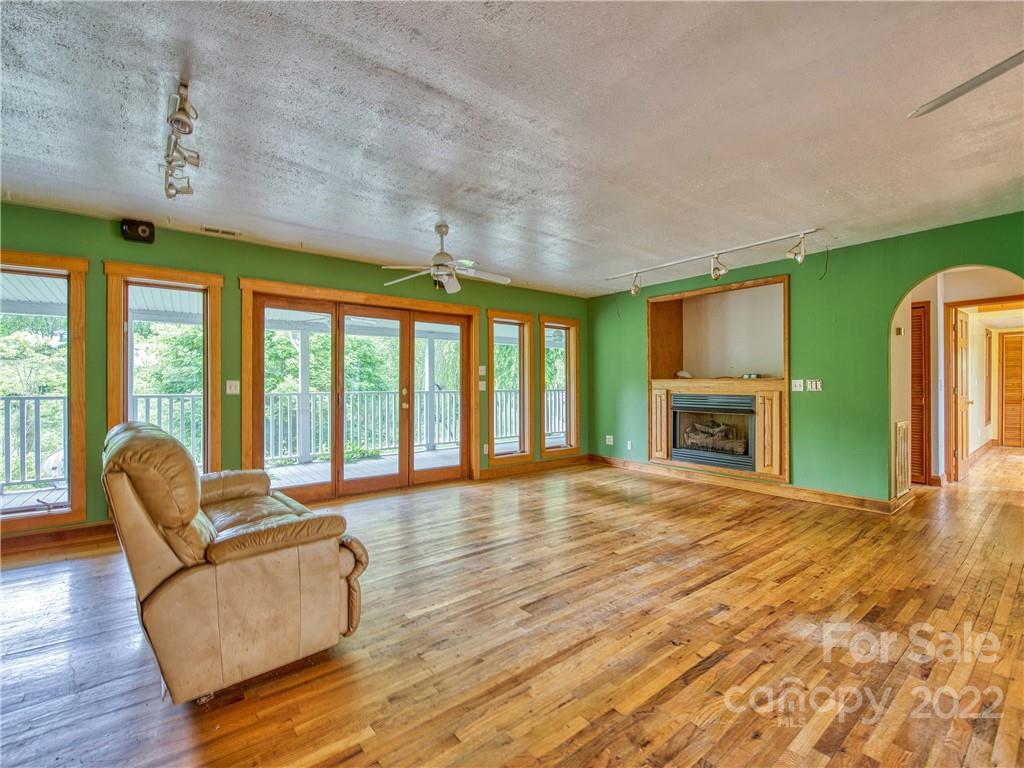 217 Durham Road Clyde, NC 28721 - Photo 9 of 24 a living room with furniture and a fireplace