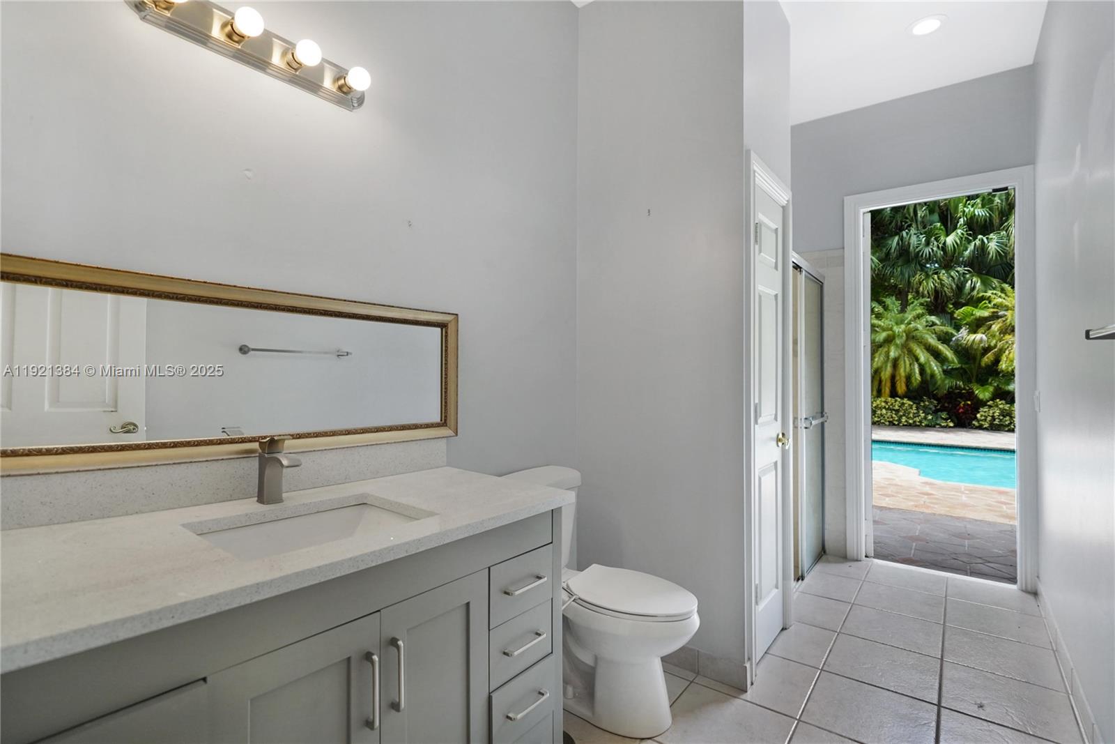 6713 Northwest 127th Terrace, Unit 1 Parkland, FL 33076 - Photo 11 of 15 a bathroom with a toilet a sink and a window