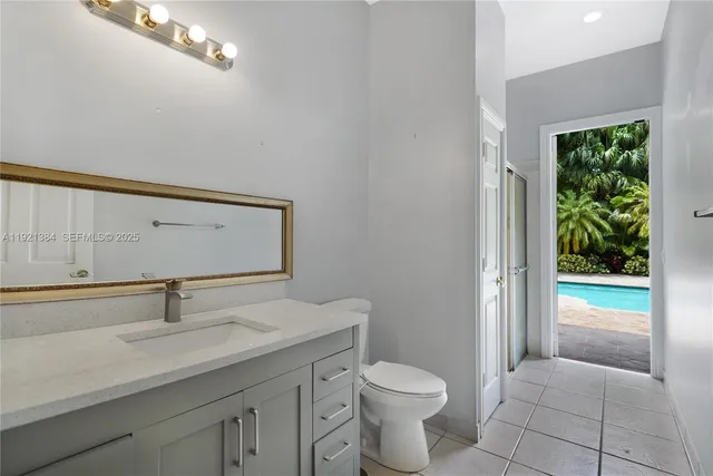 a bathroom with a toilet a sink and a window