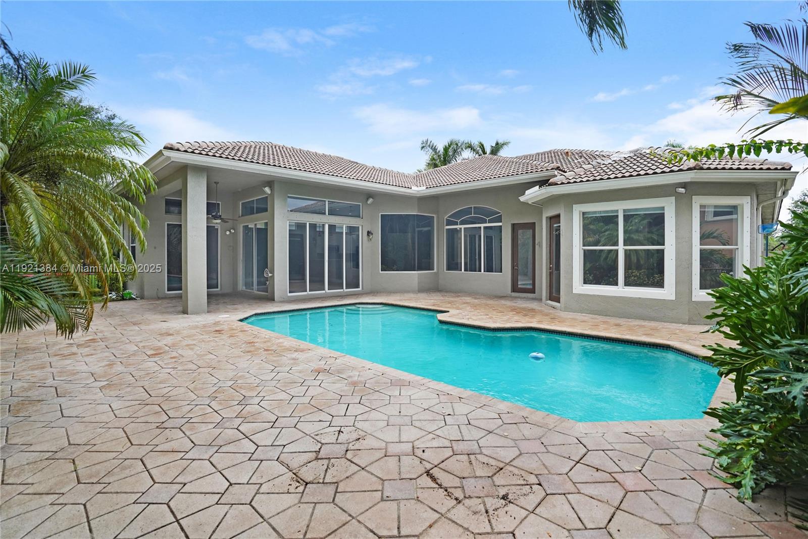 6713 Northwest 127th Terrace, Unit 1 Parkland, FL 33076 - Photo 14 of 15 a view of a house with a yard and potted plants