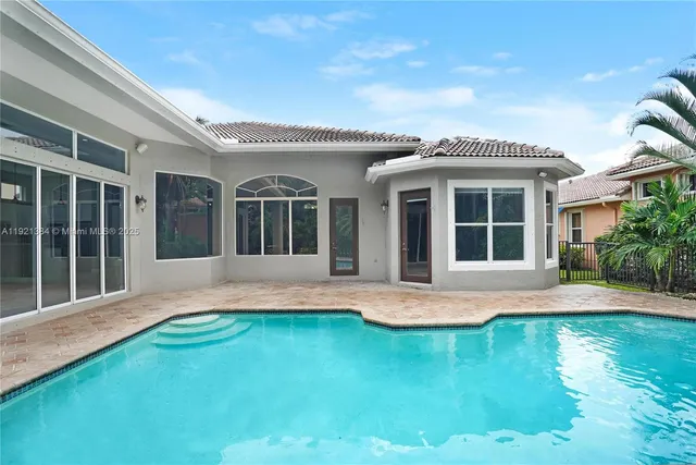 a view of an house with swimming pool and porch