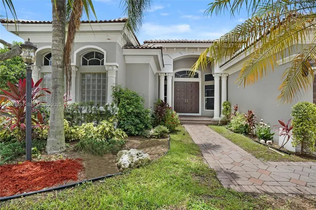 a front view of a house with garden