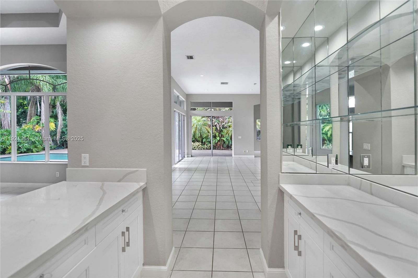 6713 Northwest 127th Terrace, Unit 1 Parkland, FL 33076 - Photo 8 of 15 a bathroom with a sink mirror and window