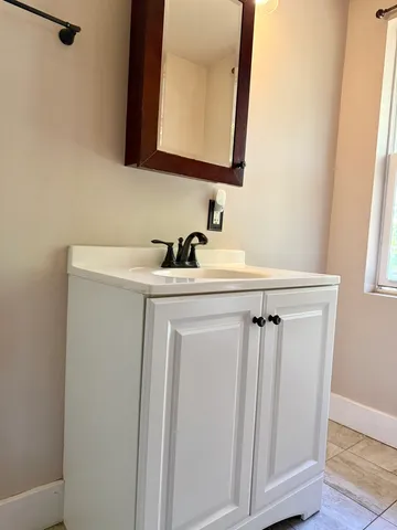 a bathroom with a sink a mirror and vanity