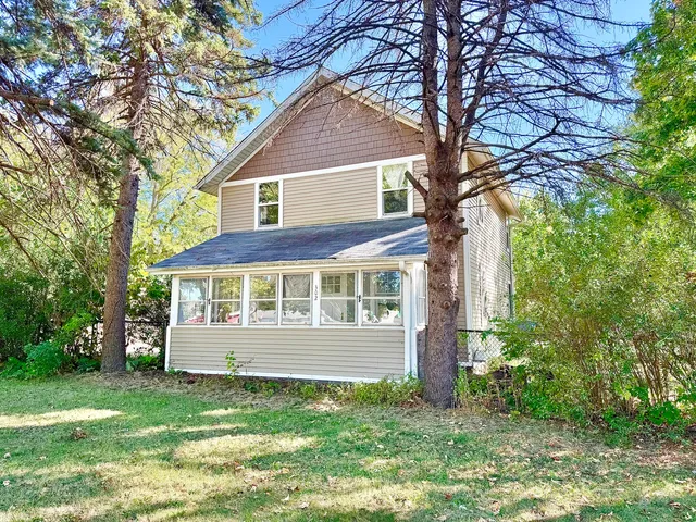 a view of house with a yard