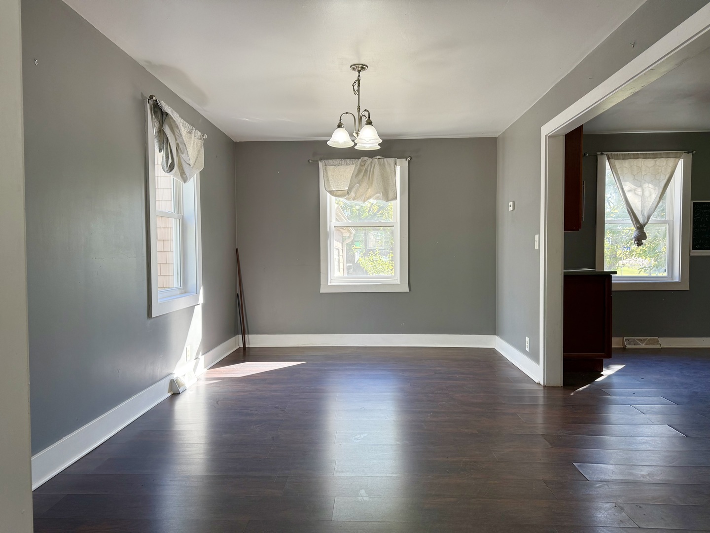 302 Highway 71 Newark, IL 60541 - Photo 6 of 19 a view of an empty room with wooden floor and a window