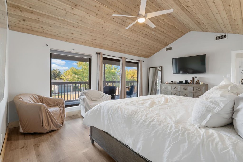 13126 Travis View Loop Austin, TX 78732 - Photo 14 of 27 Bedroom with access to exterior, light wood-type flooring, wooden ceiling, vaulted ceiling, and a ceiling fan