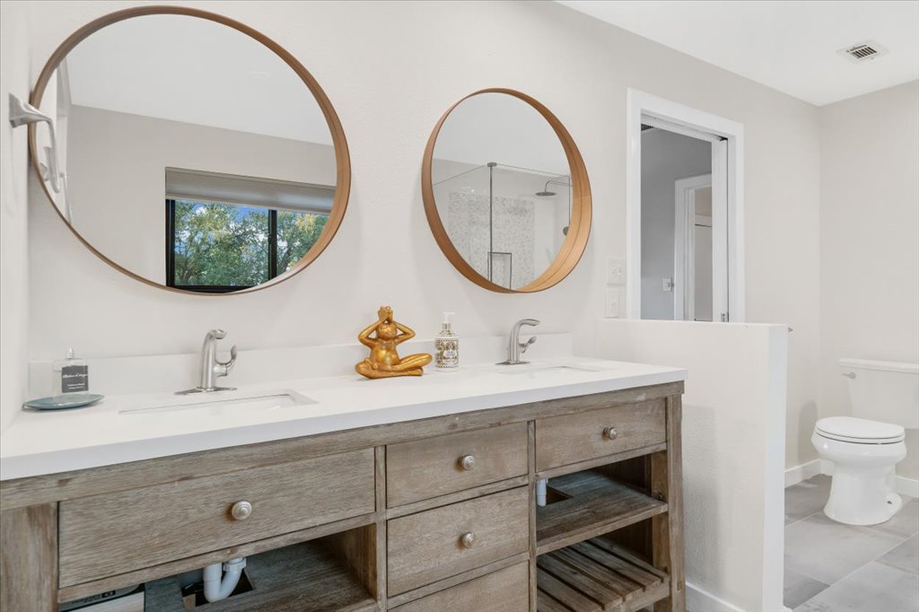 13126 Travis View Loop Austin, TX 78732 - Photo 15 of 27 Full bath with double vanity and toilet renovated in 2020