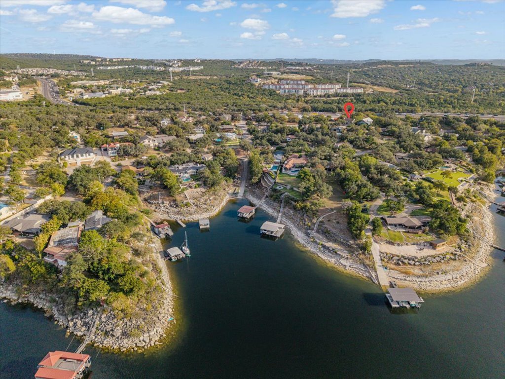 13126 Travis View Loop Austin, TX 78732 - Photo 26 of 27 Aerial view of property and surrounding area with a large body of water and a tree filled landscape