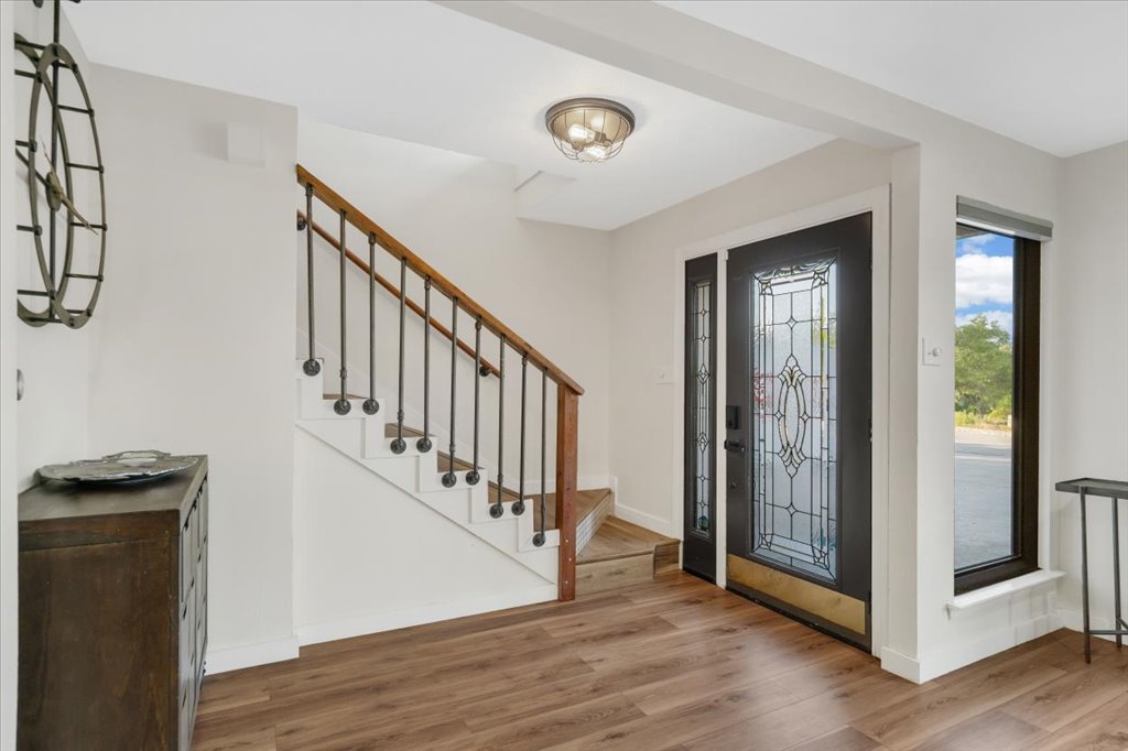 13126 Travis View Loop Austin, TX 78732 - Photo 4 of 27 Foyer entrance featuring wood finished floors and stairway