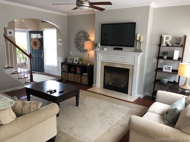 328 Sand Paver Way Fort Mill, SC 29708 - Photo 3 of 19 a living room with furniture a flat screen tv and a fireplace