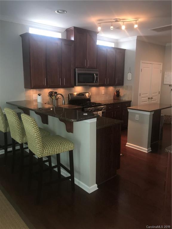 328 Sand Paver Way Fort Mill, SC 29708 - Photo 5 of 19 a kitchen with a table chairs sink and cabinets