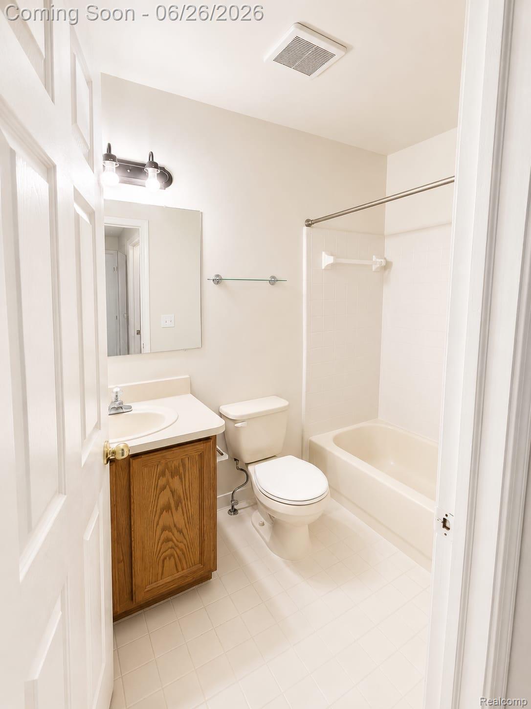 17014 Country Ridge Lane Macomb, MI 48044 - Photo 18 of 25 Bathroom featuring a wood-finish vanity, white countertop, white basin, and a mirrored medicine cabinet