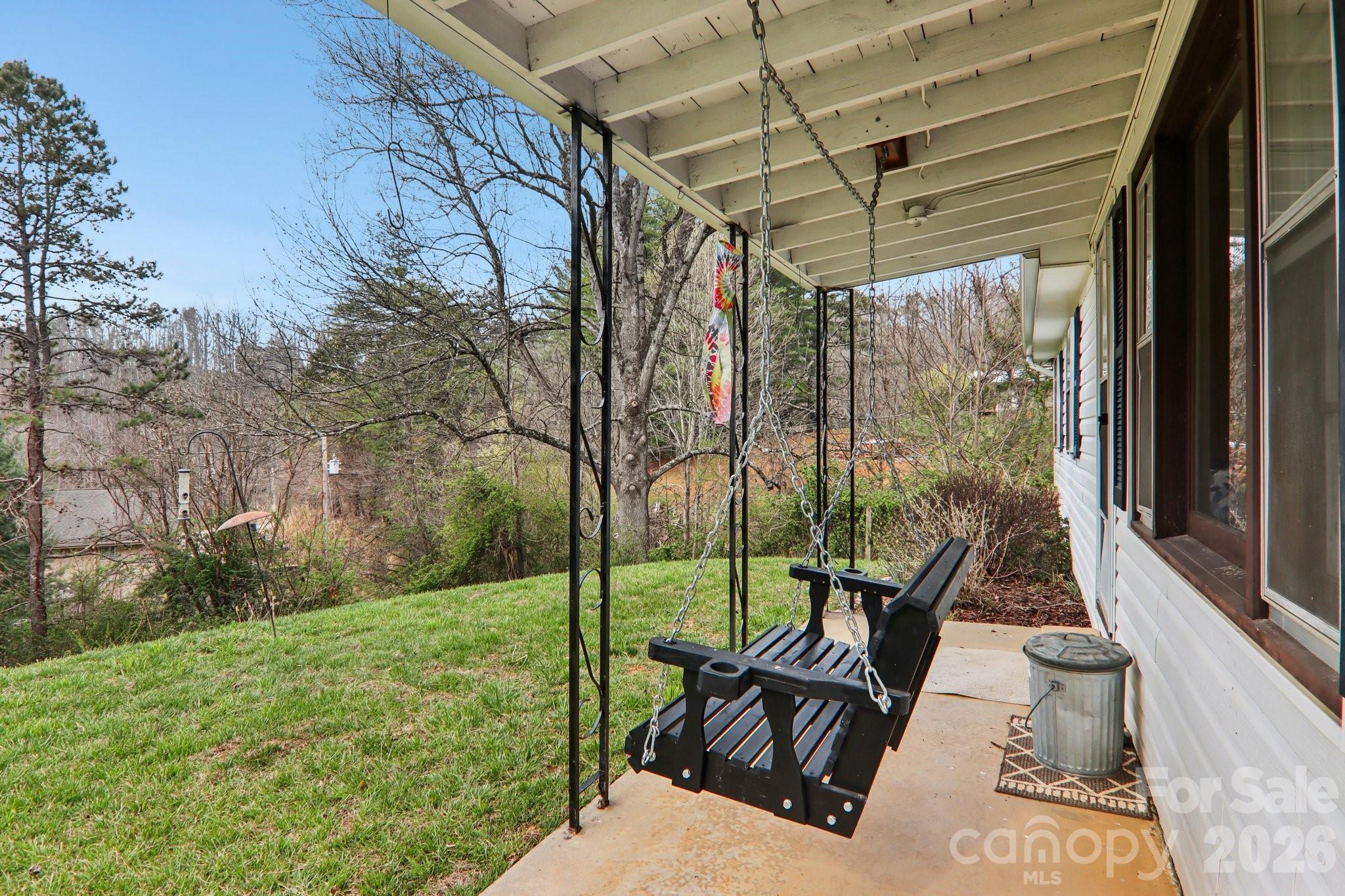 105 Baird Road Mars Hill, NC 28754 - Photo 14 of 48 a view of a deck with couches and wooden floor next to a yard