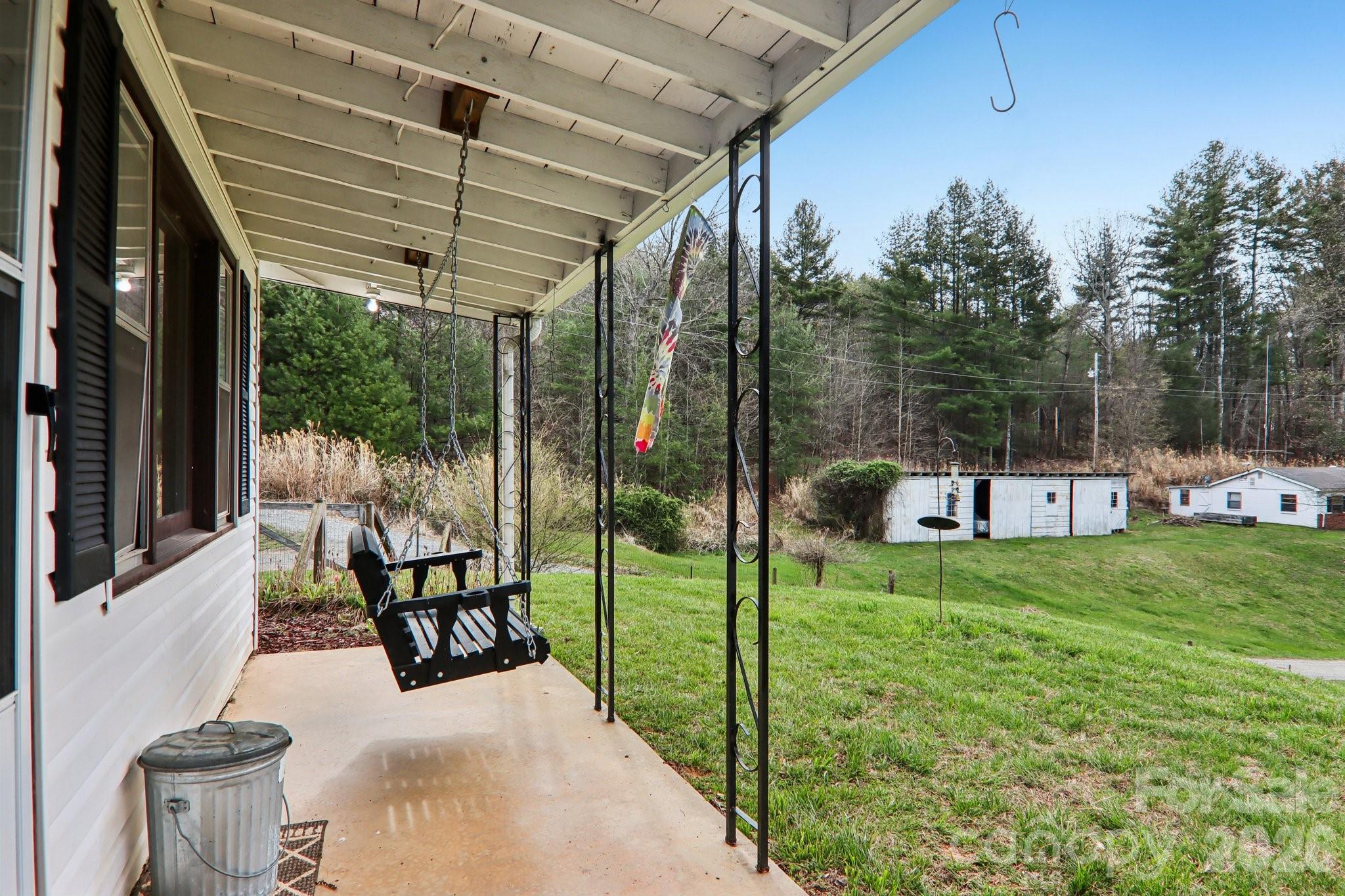 105 Baird Road Mars Hill, NC 28754 - Photo 15 of 48 a view of a porch with furniture and garden