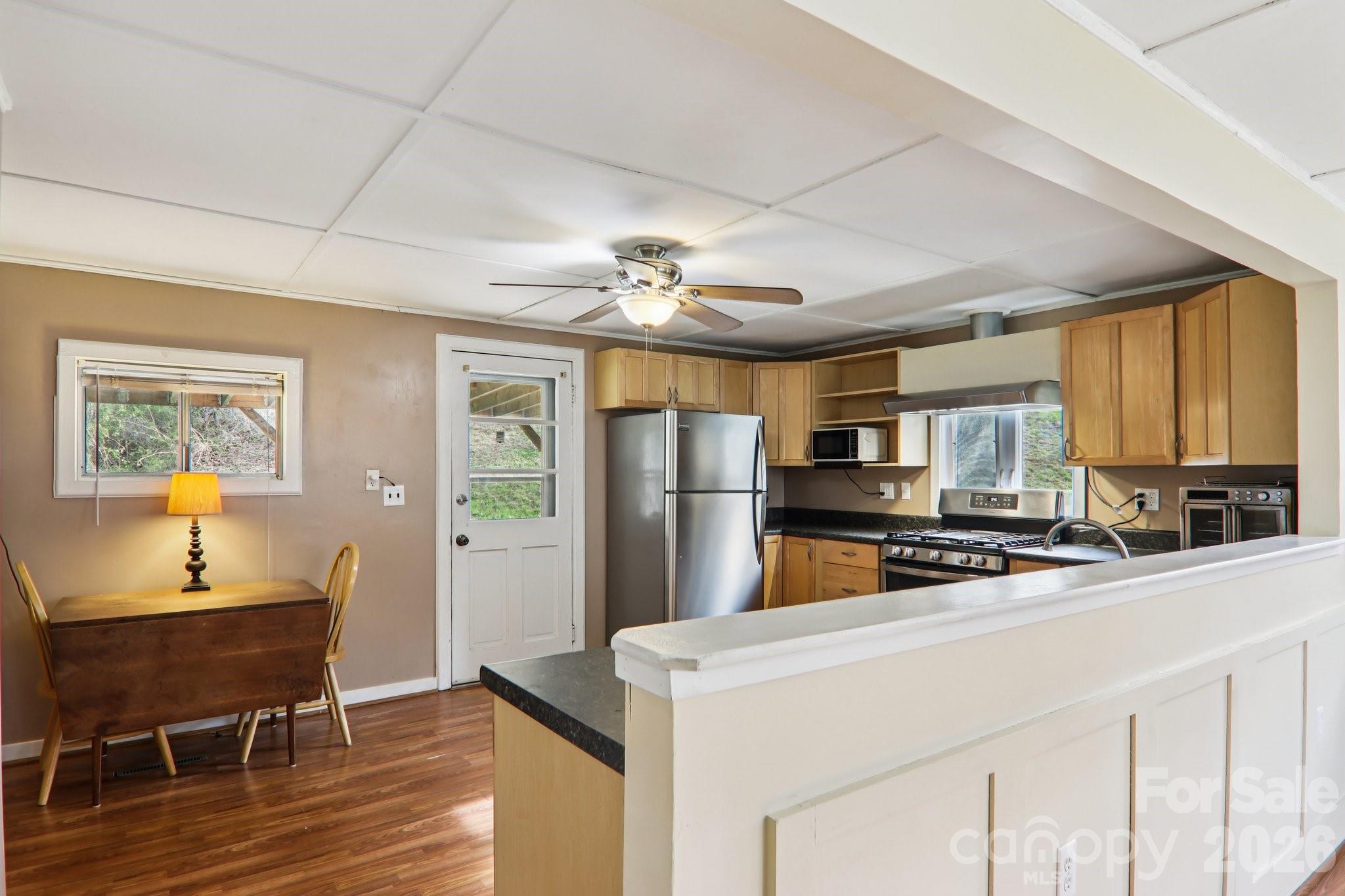 105 Baird Road Mars Hill, NC 28754 - Photo 22 of 48 a kitchen with stainless steel appliances a stove refrigerator sink and microwave