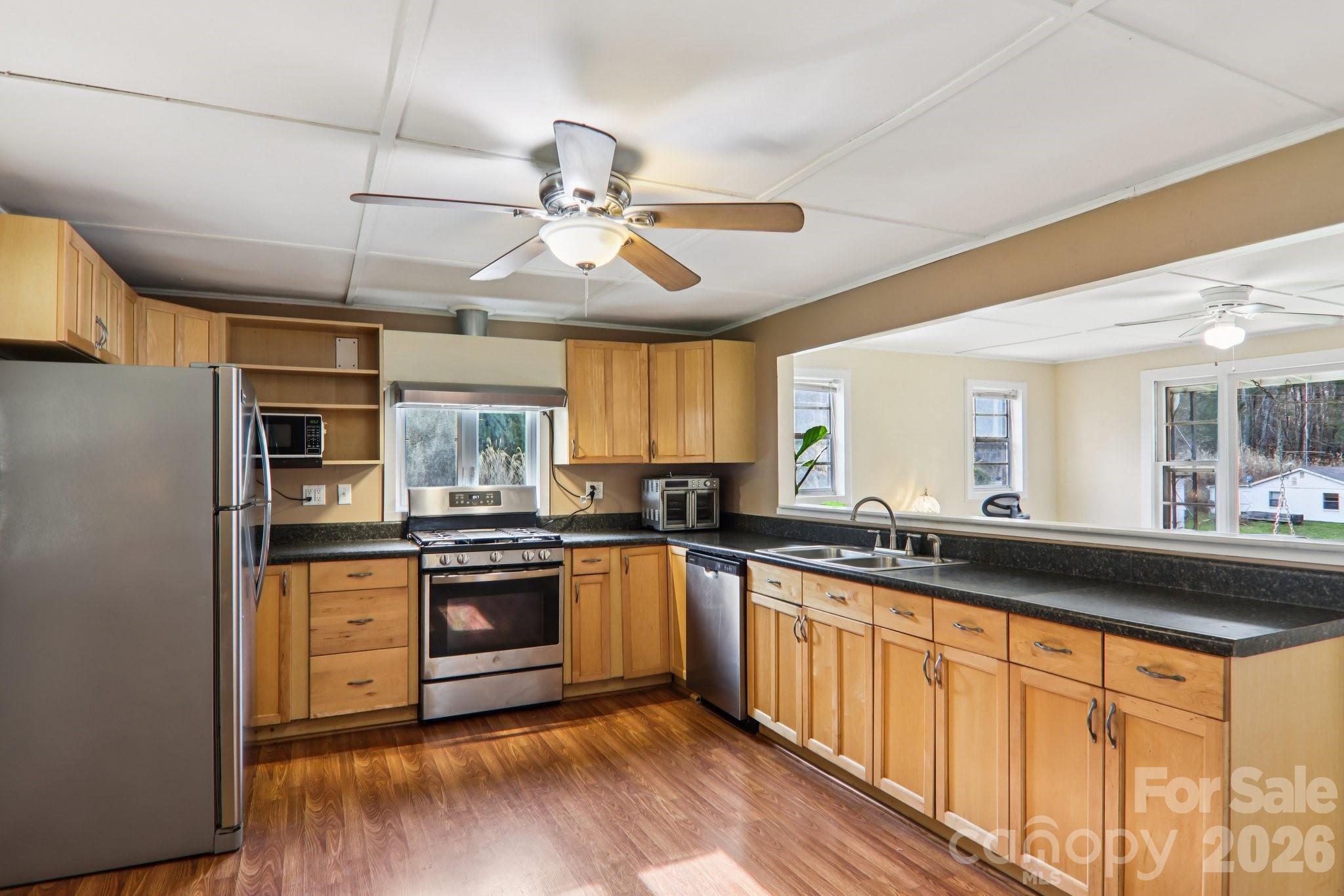 105 Baird Road Mars Hill, NC 28754 - Photo 23 of 48 a kitchen with stainless steel appliances granite countertop a stove and cabinets