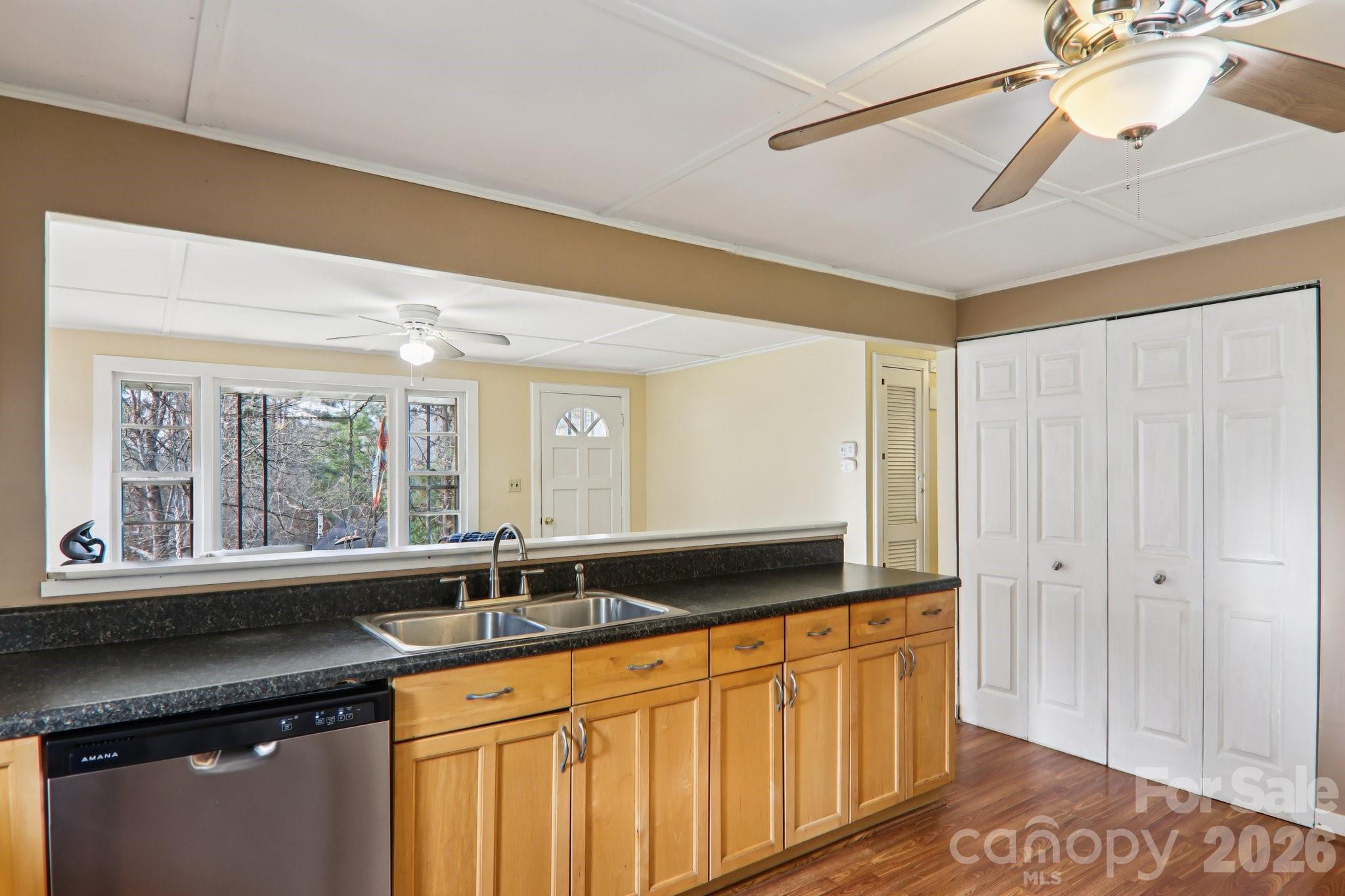 105 Baird Road Mars Hill, NC 28754 - Photo 25 of 48 a kitchen with granite countertop a sink and a window